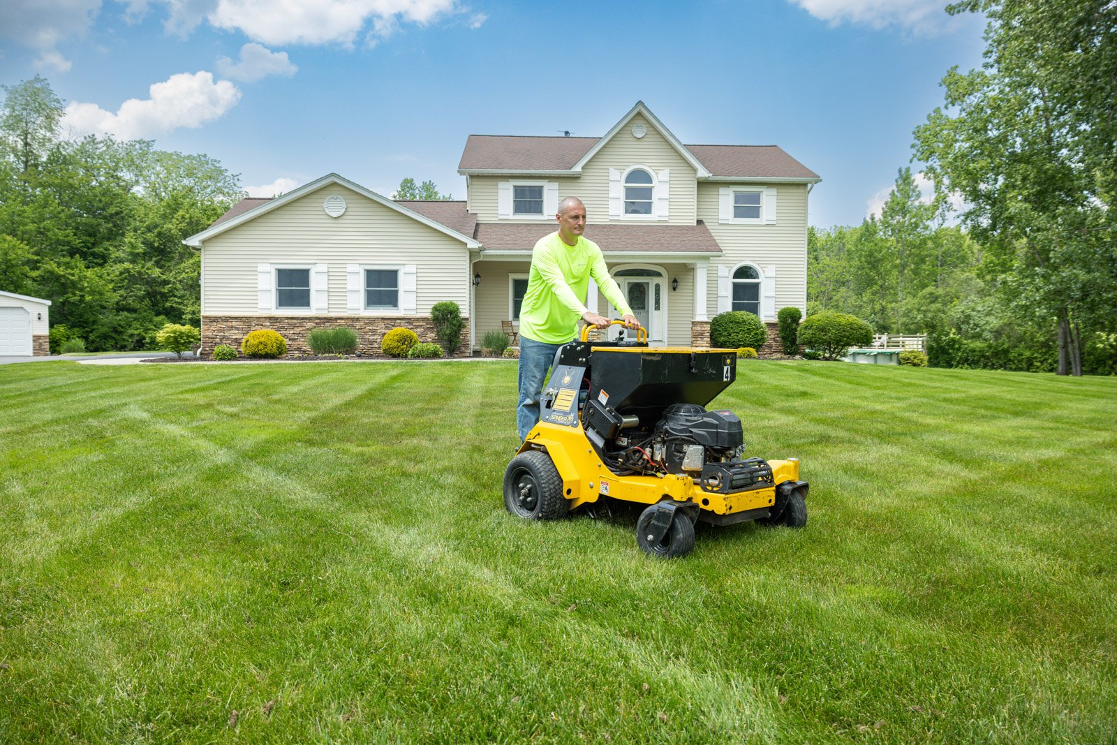 lawn care tech riding aerator overseeding grass home 2