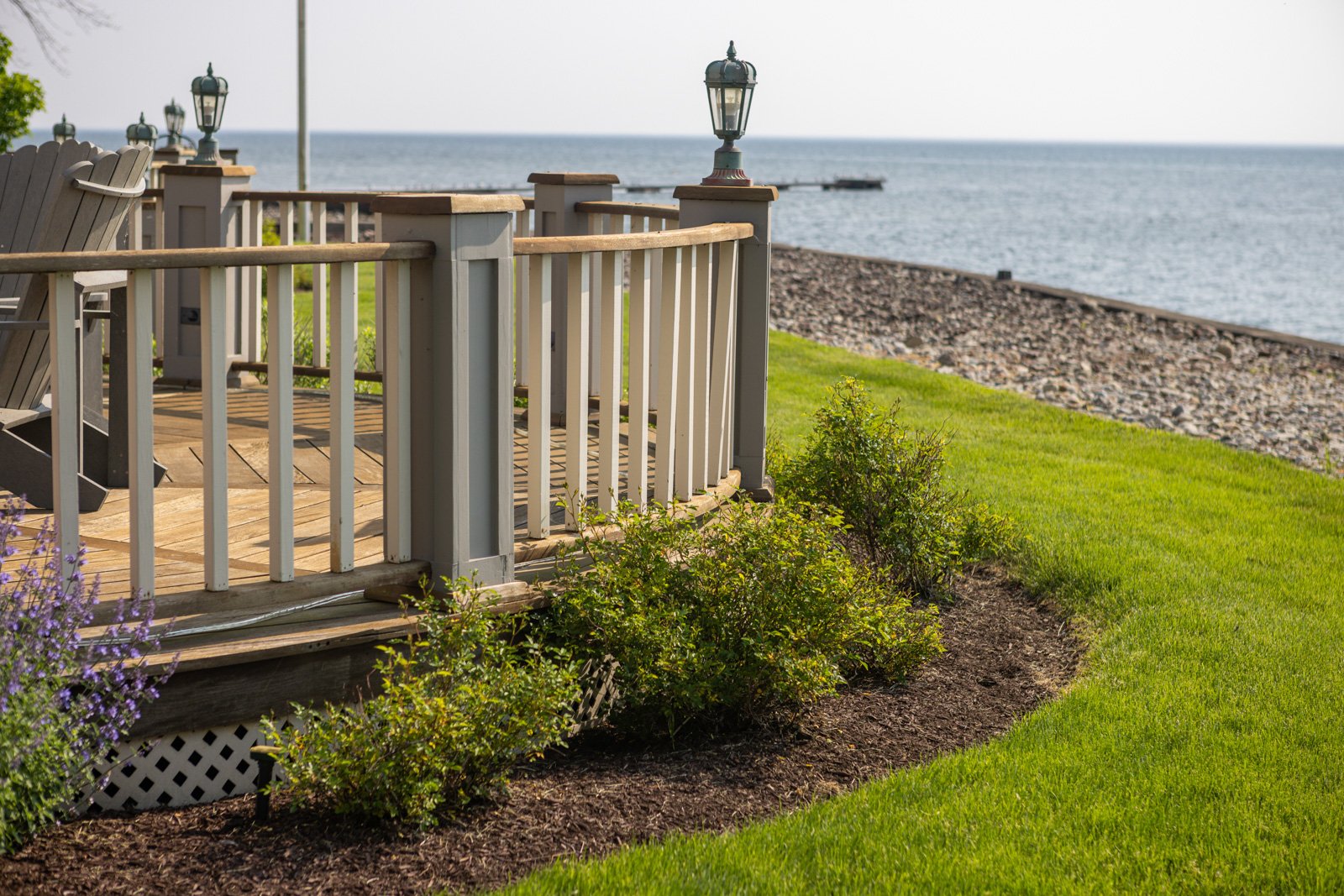 planting bed shrubs waterfront deck grass mulch