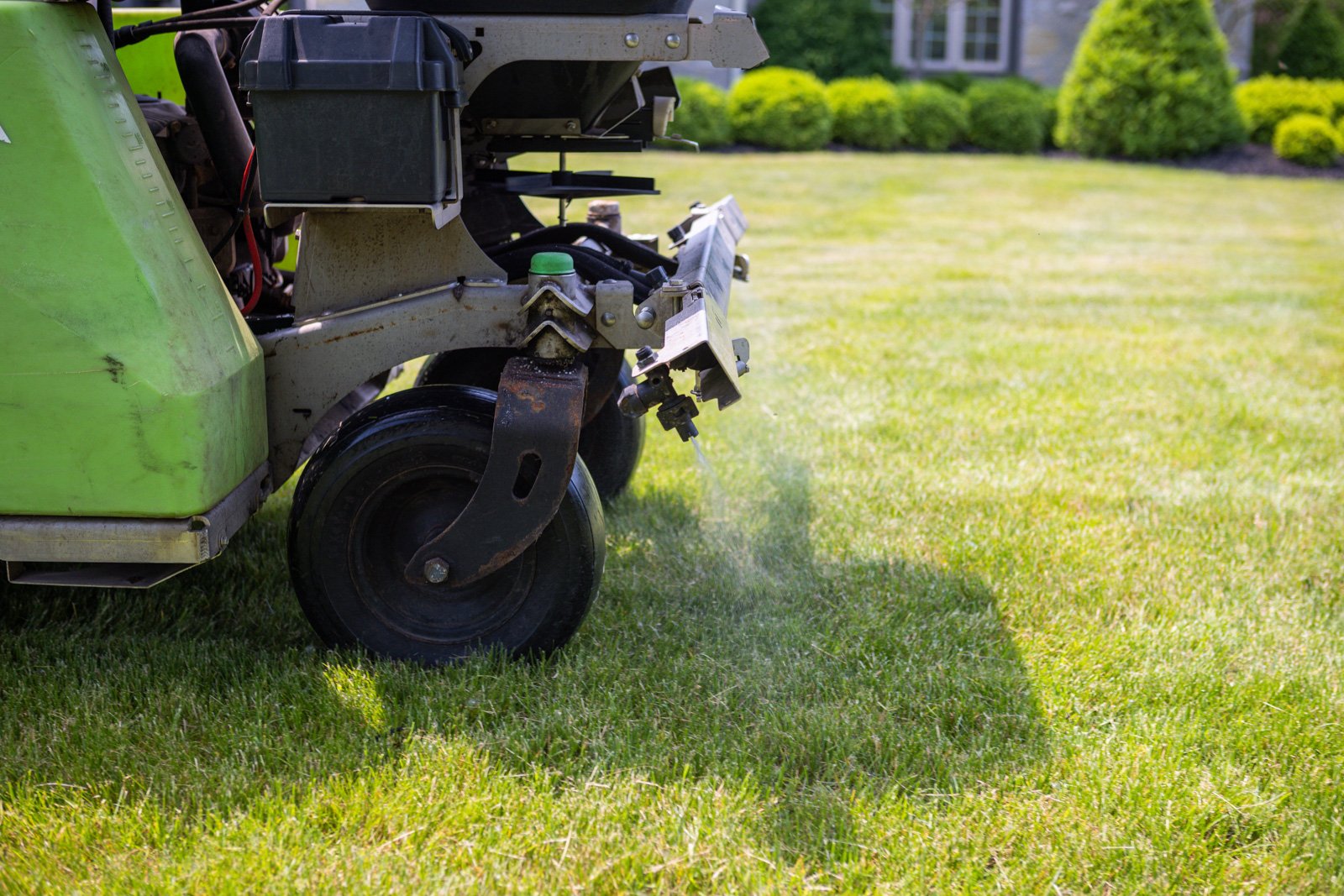 spraying a lawn for weed prevention