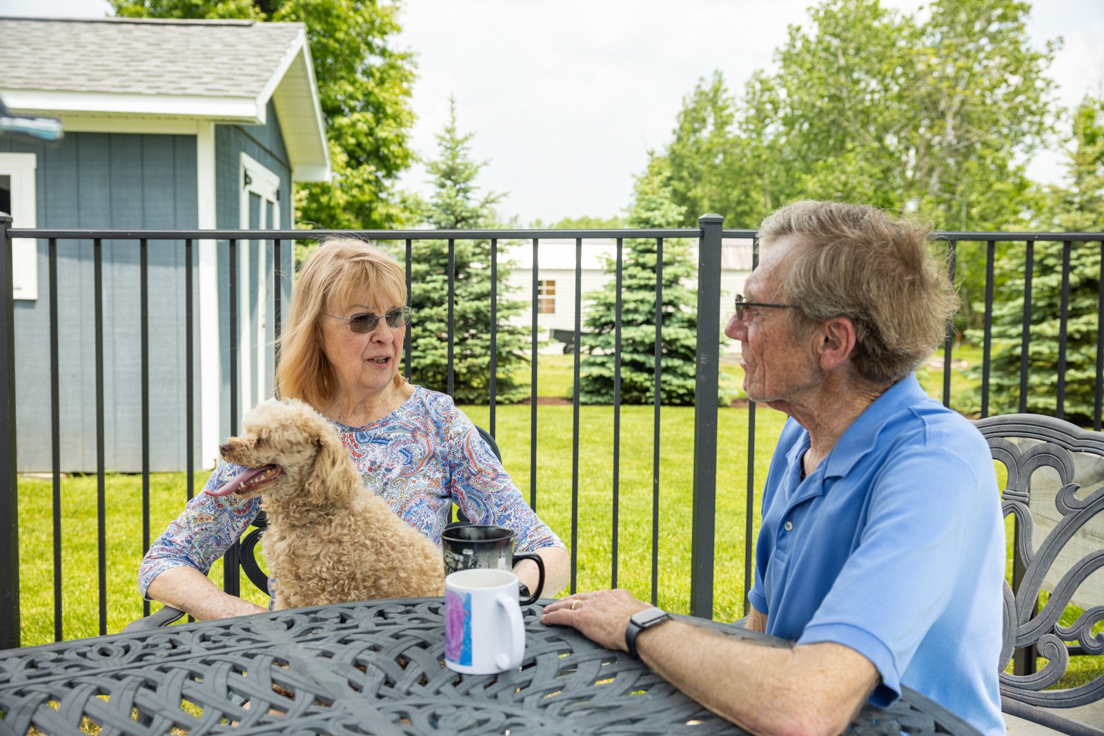 homeowners discussing their lawn care program and provider