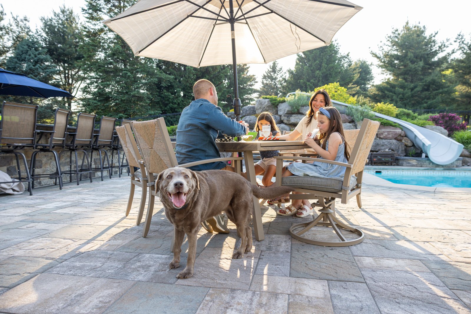 family eating outside with their dog