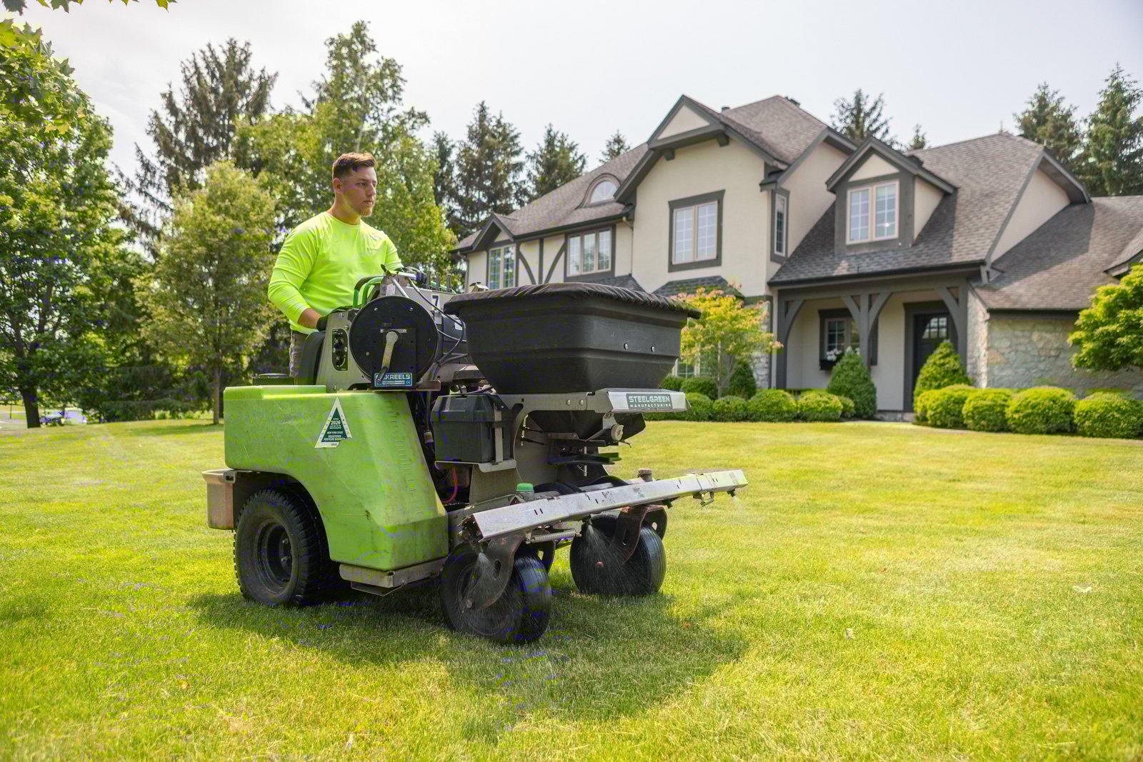 spraying liquid pre-emergent crabgrass preventer on a lawn