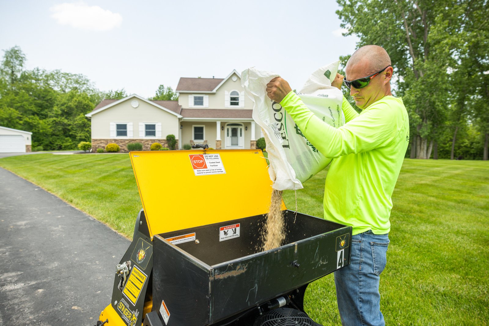 adding seed optimized for western new york to a hopper for spreading