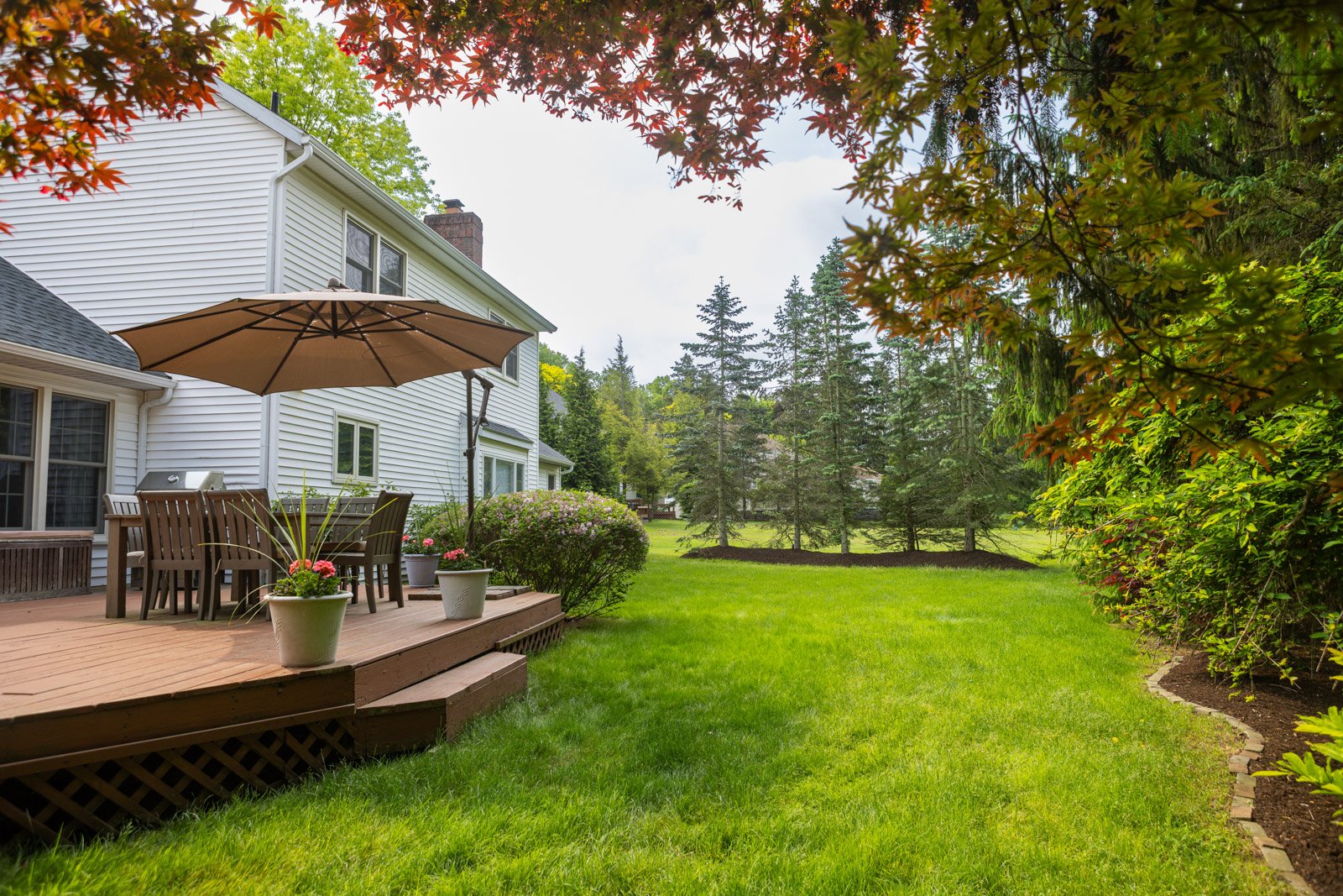 green lawn off the deck of a house