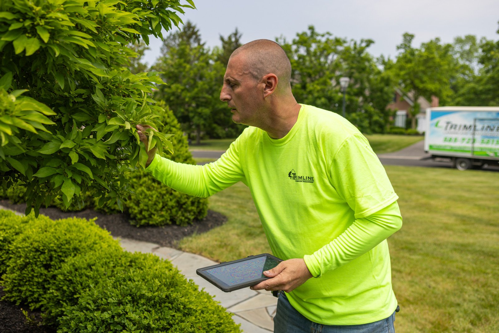 plant health care technician happy employee inspection phone tablet 3