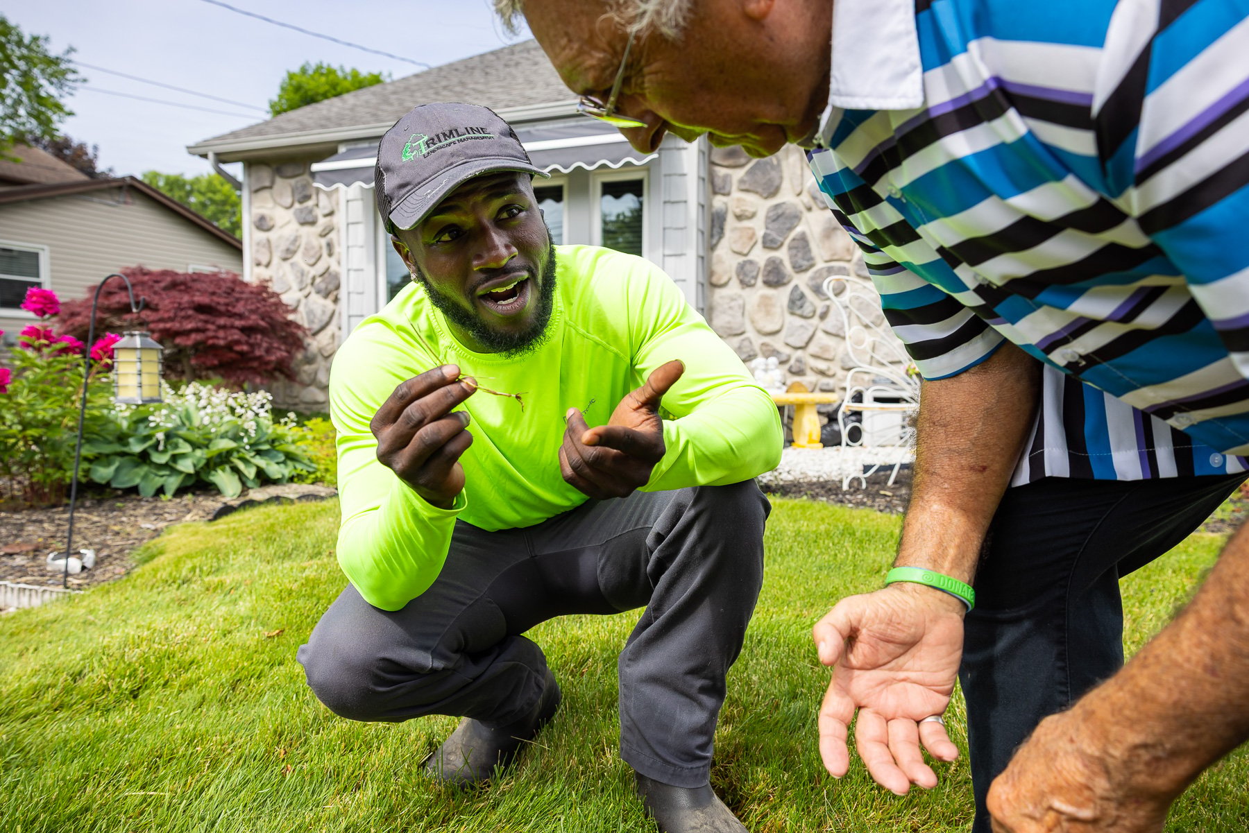 lawn care tech reviewing fall lawn problems with a homeowner